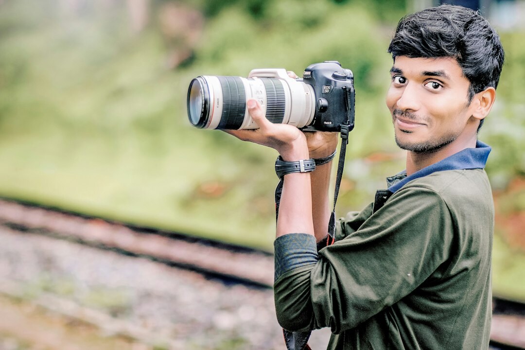 Danish male photographer holding a camera outdoors